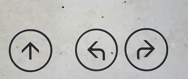 Three arrows on a concrete wall, each pointing a different direction — a visual reminder that when one path isn't working, others are always available.